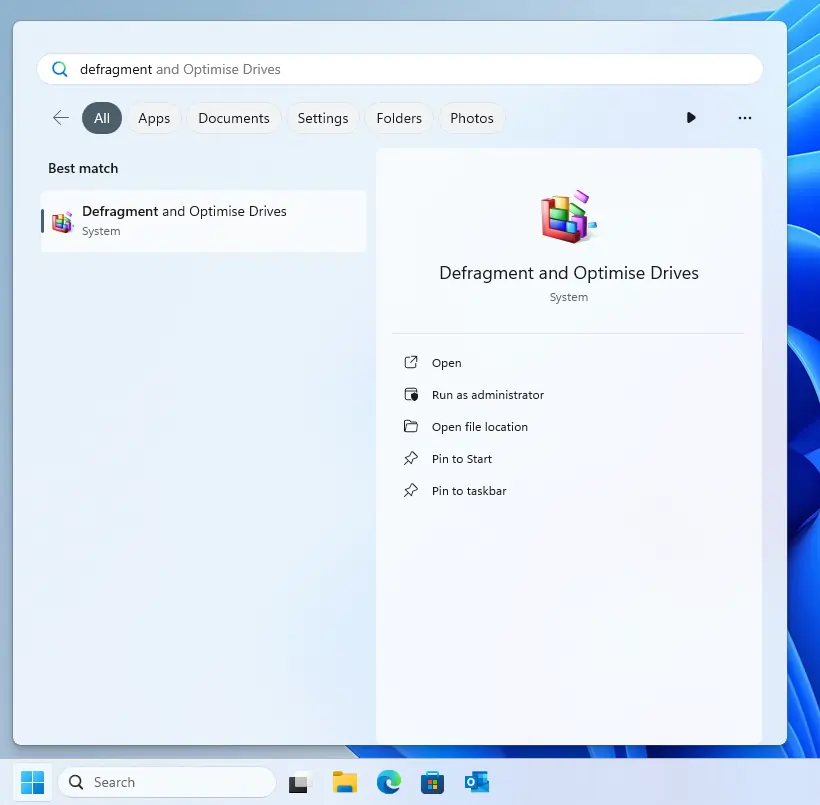 an image representing the Windows 11 search menu, Defragment and Optimise Drives is displayed.